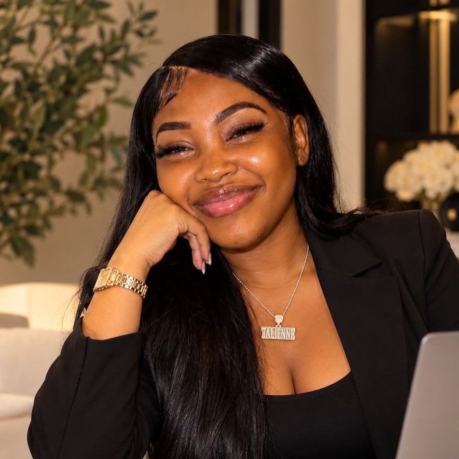 Riri, website designer, smiling at her laptop